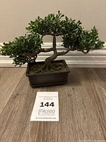 Full view of artificial bonsai tree on floor