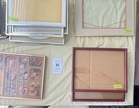 Tabletop view of assorted frames showing sizes on stickers