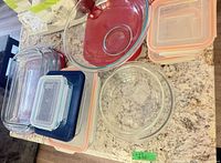 Overview of assorted glass and plastic containers on countertop