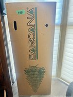 Front view of Barcana branded cardboard box containing tree