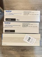 Three sealed Brother toner/drum boxes: two TN-450, one DR-420