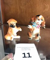 Front view of both ceramic dog figurines
