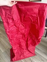 Red fabric organizer held open showing material and size
