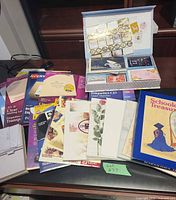 Assorted Avery label packs, decorative papers, greeting card kit and Schooldays Treasures album spread on surface