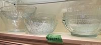 Assortment of clear glass bowls on shelf showing two plain bowls and three tree-bark bowls