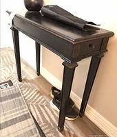 Side angle showing table profile, beaded trim, one drawer, leg detail