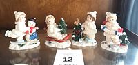 Front view of all four Snowbabies figurines on shelf
