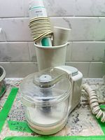 Mini food processor front view with clear bowl and blade