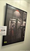 Full framed print on wall showing entire artwork and black frame