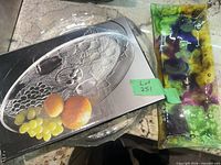 Overview showing boxed oval platter, round platter beneath, and fused glass tray