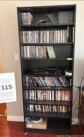 Full view of tall IKEA bookcase filled with DVDs (contents excluded)
