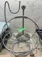 fruit basket with attached banana hook and paper towel holder in background