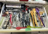 Open drawer with organizer and all utensils