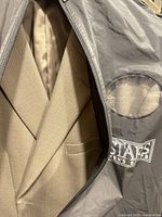 Tan blazer inside Stars Men’s Shop garment bag