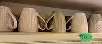 Shelf with ribbed and honeycomb mugs