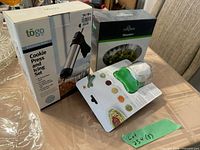 Three boxed kitchen gadgets: OXO spiralizer, Fox Run steamer, Togo cookie press