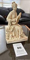 Front view of plaster figurine on glass table