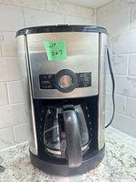 Front view of stainless steel Presidents Choice coffee maker showing control dial, buttons, and attached carafe