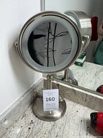 full view of brushed nickel lighted mirror on countertop