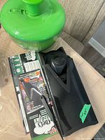 Salad spinner beside Euro-Gourmet V-Slicer and packaging