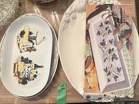Group of platters including printed cheese graphic platter, floral border platter, boxed rectangular platter