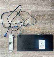 Top view of player with remote, HDMI cable, RCA cable