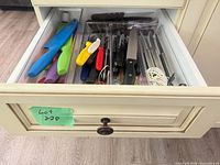 Drawer view showing assorted knives and dividers