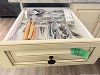 Drawer view showing entire assortment of flatware and utensils