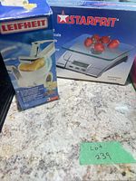 Starfrit scale box next to Leifheit grater box