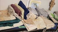 Full assortment of folded linens including packaged Danish Tabletop Collection item