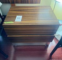 Front view of Zebrawood veneer two-drawer nightstand on metal base