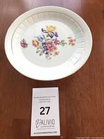 Overall view of porcelain cake stand with floral design and lot card