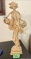Front view of resin geisha sculpture on plinth base
