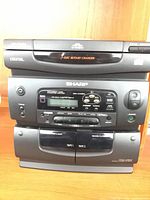 Front of Sharp CD-C440C stereo showing 3-disc changer, control panel and cassette decks