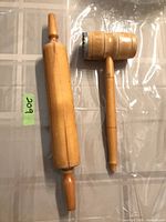 Rolling pin and meat tenderizer mallet side by side