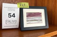 Framed painting beside size card