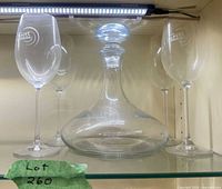 Set showing decanter with stopper flanked by four wine glasses