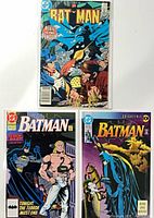 Front covers of Batman issues 374, 469, 494 in protective sleeves