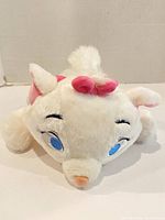 Front view of white Marie plush with blue eyes and pink bow