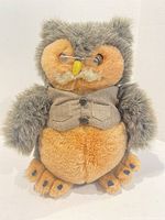 Front view of owl plush showing glasses, vest, colors, beak, claws