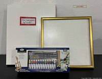 Full lot showing paint kit box, stack of five canvases, gold frame