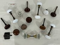 Group shot showing all knobs and latch laid out on cloth