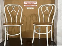 Front view of both Frank & Sons tubular steel bistro chairs