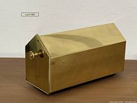 overall view of brass mailbox showing gabled shape and brass finish