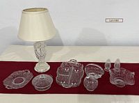 Full lot showing lamp, seven crystal serving pieces, salt & pepper, table runner