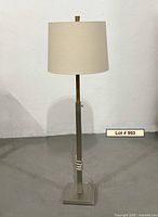 Full view of floor lamp showing base, column, and shade