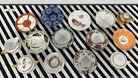 Top-down overview of all teacups, saucers, sugar bowl and creamer