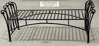 Full view of bench front showing slatted seat, scroll arms, arched stretcher