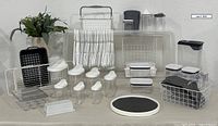 Full lot view showing storage bin, baskets, hangers, canisters, drying rack, butter dish, lazy susan and faux plant