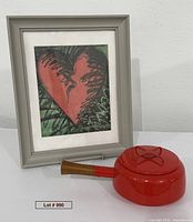Framed print and red Dansk saucepan displayed together